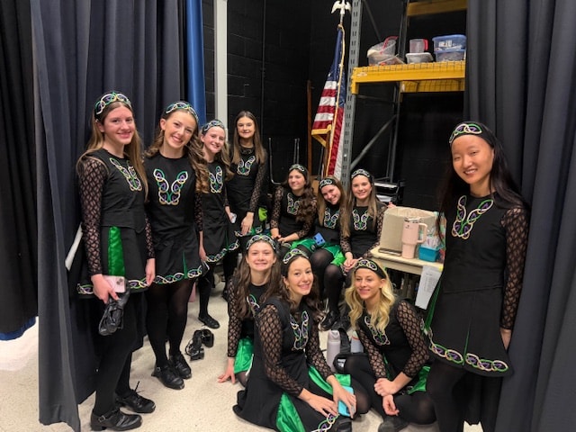 Large group of Fitzpatrick dancers in Celtic costumes backstage before a performance