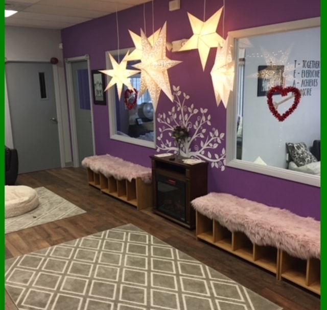 Studio lobby wide view with star lanterns, two benches, and Valentine heart wreath