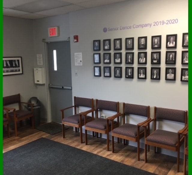 Senior Dance Company portrait wall with framed black and white photos and waiting area seating